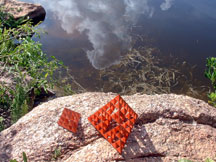 Natural fractals don't use man-made shapes.  For instance, tree branches and clouds and waves aren't made of tetrahedrons.